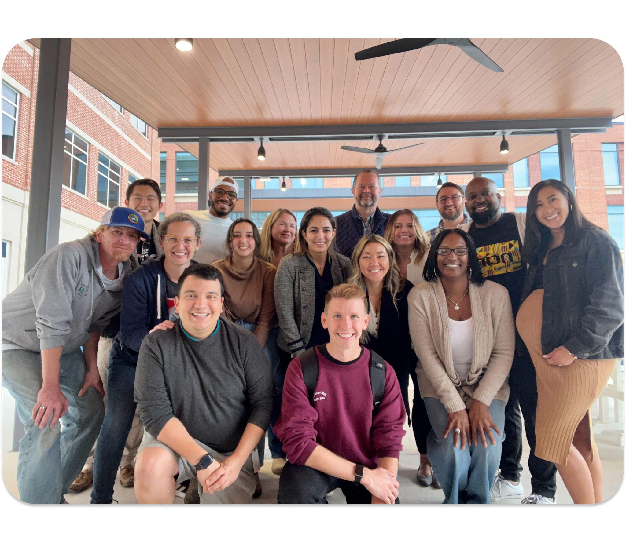 A group of nCino leaders for the diversity, equity, and inclusion council smile at the camera under a covered patio outside. 