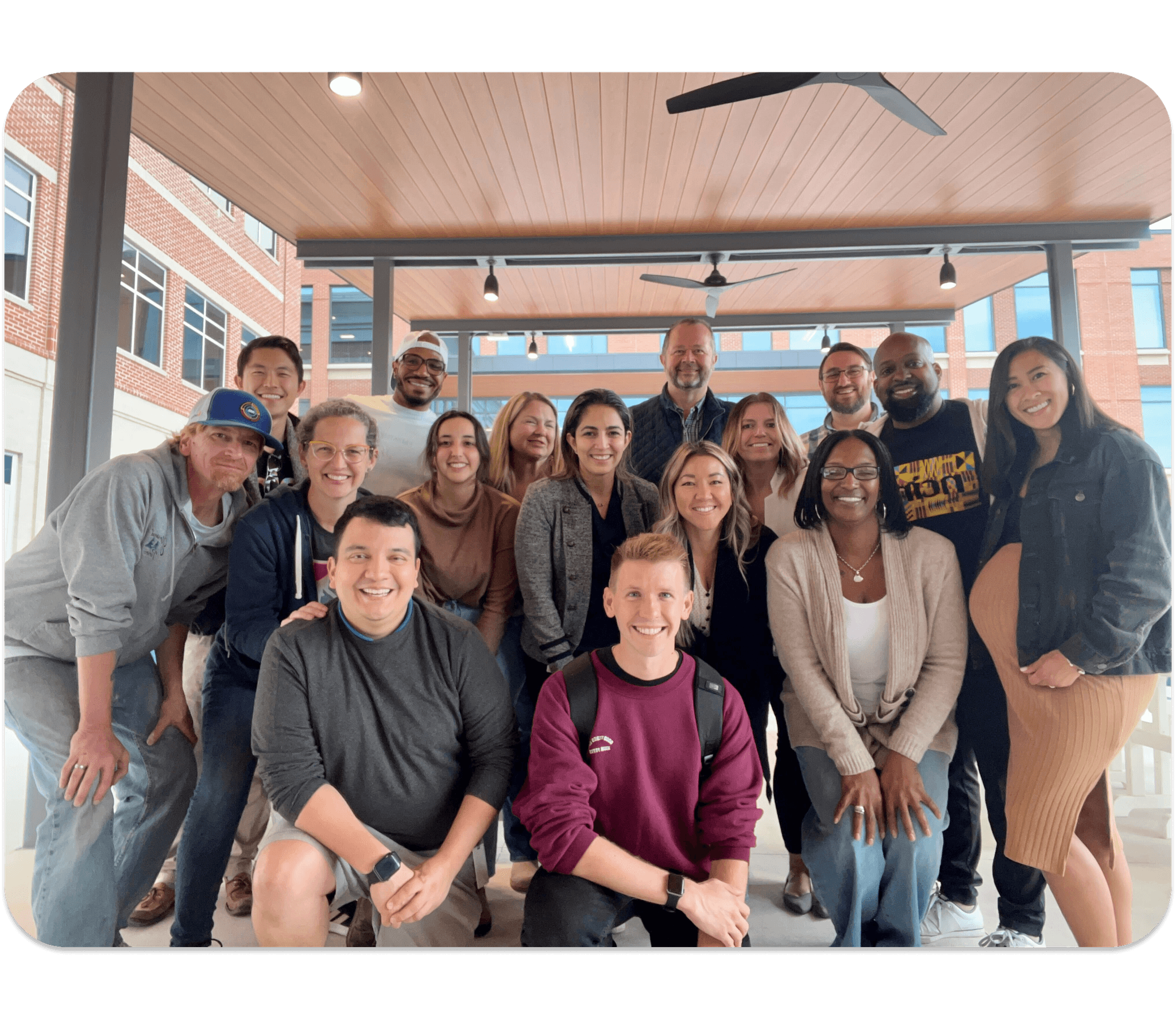 A group of nCino leaders for the diversity, equity, and inclusion council smile at the camera under a covered patio outside. 