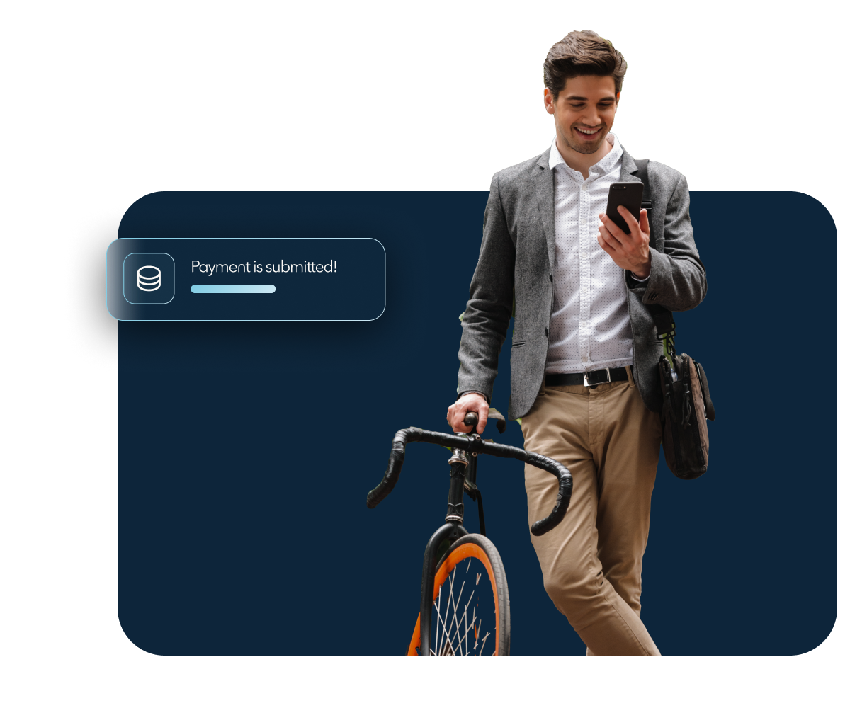 A man standing with his bicycle looking at his phone